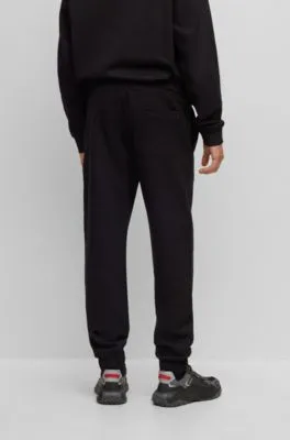 Relaxed-fit cotton-terry tracksuit bottoms with stacked logo