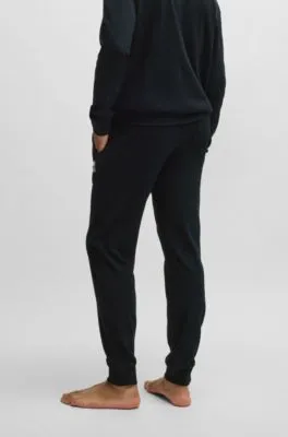 Tracksuit bottoms with metallic logo label