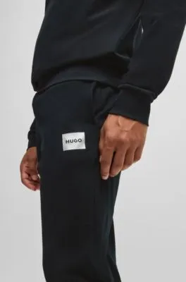 Tracksuit bottoms with metallic logo label